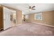A spacious bedroom featuring a ceiling fan, ample windows, and access to an ensuite bathroom at 4531 Montibello Dr, Charlotte, NC 28226