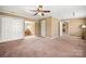 Neutral bedroom features a ceiling fan, double closets, and access to an adjacent room at 4531 Montibello Dr, Charlotte, NC 28226