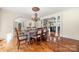 Formal dining room featuring hardwood floors, elegant lighting, and easy access to kitchen and living areas at 4531 Montibello Dr, Charlotte, NC 28226