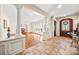 Elegant foyer featuring stone floors, decorative columns, and a view of the formal dining room at 4531 Montibello Dr, Charlotte, NC 28226