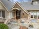 Charming front entrance featuring a wooden door, brick accents, and a welcoming arched porch at 4531 Montibello Dr, Charlotte, NC 28226