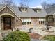 Inviting front entrance with a stone patio, decorative fountain, and meticulously landscaped surroundings at 4531 Montibello Dr, Charlotte, NC 28226