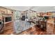 Open-concept living room with hardwood floors, stone fireplace, and seamless flow to the kitchen and dining area at 4531 Montibello Dr, Charlotte, NC 28226