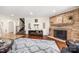 Comfortable living room featuring hardwood floors, a stone fireplace, and a staircase leading to the upper level at 4531 Montibello Dr, Charlotte, NC 28226