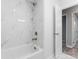 Bathroom with a tiled shower and tub, and white walls throughout at 5329 Southampton Rd, Charlotte, NC 28217