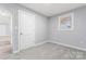 Bright bedroom featuring new carpet, door and window at 5329 Southampton Rd, Charlotte, NC 28217