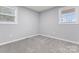 Bright bedroom with neutral paint, plush carpet, and natural light streaming through the windows at 5329 Southampton Rd, Charlotte, NC 28217