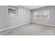 Bright bedroom with plush carpeting, neutral walls, and a large window providing plenty of natural light at 5329 Southampton Rd, Charlotte, NC 28217