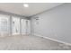 Bedroom with neutral paint, carpeted floor, window, and a closet at 5329 Southampton Rd, Charlotte, NC 28217