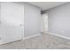 Clean bedroom with plush carpet, white doors and a glimpse into a white and bright bathroom at 5329 Southampton Rd, Charlotte, NC 28217