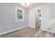 Cozy bedroom featuring neutral paint, light gray flooring, and a window at 5329 Southampton Rd, Charlotte, NC 28217