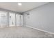 Bedroom with light gray walls, plush carpeting, and built-in wardrobe, creating a serene atmosphere at 5329 Southampton Rd, Charlotte, NC 28217
