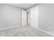 Cozy bedroom with plush carpet, two white doors, and a neutral paint scheme at 5329 Southampton Rd, Charlotte, NC 28217