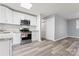 Modern kitchen with granite countertops, stainless steel appliances, and new LVP flooring at 5329 Southampton Rd, Charlotte, NC 28217