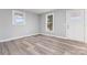 Bright living room featuring fresh paint, luxury vinyl plank flooring, and modern windows at 5329 Southampton Rd, Charlotte, NC 28217