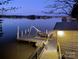 Private boat dock with a slide, chairs, and table, perfect for relaxing and enjoying the waterfront views at 547 Lake Shore Dr, Norwood, NC 28128