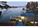 Scenic view of a boat dock with a slide, ideal for lakeside relaxation and summer fun with the water close by at 547 Lake Shore Dr, Norwood, NC 28128