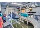 Organized boat house with multiple watercraft lifts, paddleboards, and storage, maximizing space for water sports at 547 Lake Shore Dr, Norwood, NC 28128