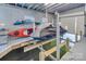 Clean and organized boat house with a jet ski lift and kayak storage, ideal for water sports enthusiasts at 547 Lake Shore Dr, Norwood, NC 28128