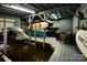 Spacious boat house featuring multiple boat and paddleboard storage lifts, perfect for waterfront activities at 547 Lake Shore Dr, Norwood, NC 28128