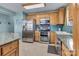 Bright kitchen with stainless steel appliances, ample cabinetry, and granite countertops at 547 Lake Shore Dr, Norwood, NC 28128