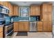 Well-lit kitchen boasts modern appliances, wooden cabinets, and stylish backsplash tiles at 547 Lake Shore Dr, Norwood, NC 28128