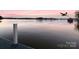 Scenic lake view at sunset with a bird flying overhead and the water in the foreground at 547 Lake Shore Dr, Norwood, NC 28128