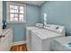 Laundry room featuring washer, dryer and laminate countertops and flooring with window at 547 Lake Shore Dr, Norwood, NC 28128