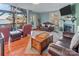Bright living room showcases a brick fireplace, plush leather furniture, and scenic views at 547 Lake Shore Dr, Norwood, NC 28128