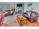 Cozy living room features a brick fireplace, hardwood floors, and comfortable leather furniture at 547 Lake Shore Dr, Norwood, NC 28128
