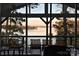 Inviting screened porch with water views, seating, and a glimpse of the serene lake at 547 Lake Shore Dr, Norwood, NC 28128
