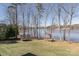 Lush backyard featuring a trampoline and custom tree house overlooking the serene lakefront property at 5628 Creole Rd, Clover, SC 29710