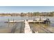 Lake house dock featuring a boat and jet ski lift for easy water access and recreational fun at 5628 Creole Rd, Clover, SC 29710