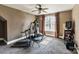Bright exercise room with neutral walls, carpet flooring, ceiling fan, exercise machine and window letting in natural light at 5628 Creole Rd, Clover, SC 29710