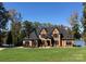 A beautiful brick home featuring multiple gables, black shutters, and a lush green lawn at 5628 Creole Rd, Clover, SC 29710