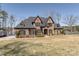 Brick home featuring multiple gables, black shutters, with grass yard and lake view at 5628 Creole Rd, Clover, SC 29710