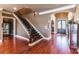 Entry foyer with hardwood floors, decorative staircase, and glass cabinet at 5628 Creole Rd, Clover, SC 29710