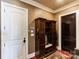 Convenient mudroom with a storage bench, coat hooks, and a dark wood door at 5628 Creole Rd, Clover, SC 29710