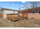 A spacious wooden deck located at the back of a brick home, perfect for relaxing outdoors at 602 Charles Rd, Shelby, NC 28152