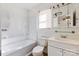 Bright bathroom featuring a shower-tub combo, toilet and single sink vanity at 602 Charles Rd, Shelby, NC 28152