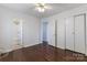 Bright bedroom with hardwood floors, closet, ceiling fan, and access to an ensuite bathroom at 602 Charles Rd, Shelby, NC 28152