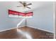 This bedroom is painted blue with hardwood floors, and a ceiling fan at 602 Charles Rd, Shelby, NC 28152