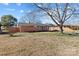 Single story brick home with a covered carport and mature trees at 602 Charles Rd, Shelby, NC 28152