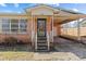 Charming brick home featuring a covered front porch and convenient carport at 602 Charles Rd, Shelby, NC 28152