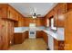 Spacious kitchen featuring wooden cabinets, white appliances, and tile backsplash at 602 Charles Rd, Shelby, NC 28152