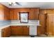 The kitchen features wooden cabinets, white appliances, and tile flooring at 602 Charles Rd, Shelby, NC 28152