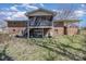 Back view of a brick home featuring a screened porch, a covered patio, and a spacious backyard at 607 Dick St, Albemarle, NC 28001