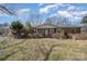 Charming single-story brick home with a covered front porch, mature landscaping, and a well-maintained lawn at 607 Dick St, Albemarle, NC 28001