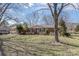 Inviting single-story brick home nestled in a quiet neighborhood setting with mature trees and a spacious front yard at 607 Dick St, Albemarle, NC 28001