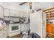 Outdated kitchen features older appliances, worn cabinetry, and cluttered surfaces, presenting a renovation opportunity at 607 Dick St, Albemarle, NC 28001
